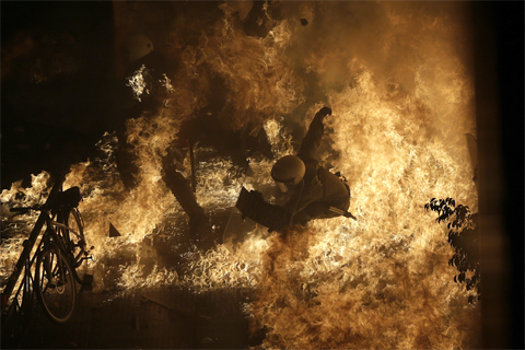 A[-]police[-]officer[-]was[-]engulfed[-]by[-]flames[-]in[-]Athens[-]Nov.[-]7.[-]Thousands[-]of[-]Greek[-]workers[-]staged[-]a[-]rally[-]outside[-]the[-]country’s[-]parliament[-]as[-]lawmakers[-]passed[-]another[-]raft[-]of[-]deep[-]wage[-]cuts[-]and[-]tough[-]labor[-]reforms.[-]Greek[-]Parliament[-]Employees[-]Vote[-]With[-]Their[-]Feet[-]Dimitri[-]Messinis/Associated[-]Press