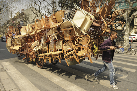 A[-]man[-]pulled[-]a[-]carload[-]of[-]wicker[-]chairs[-]down[-]a[-]street[-]in[-]Shanghai[-]April[-]5